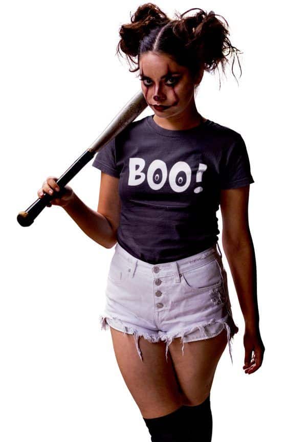 Girl in scary Halloween face makeup, carrying a bat, wearing a shirt that says Boo!